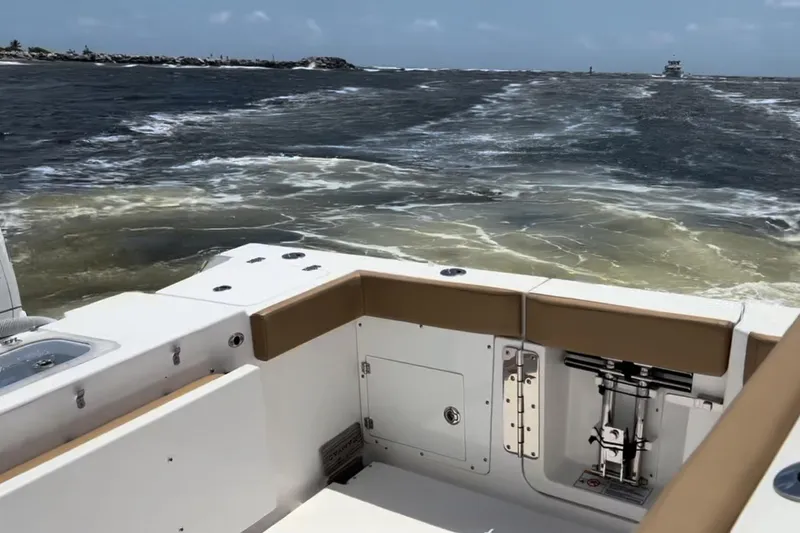 Slide: The Image of 2023 Caymas 341 CC boat cruising on open water, showcasing sleek deck design. - 34