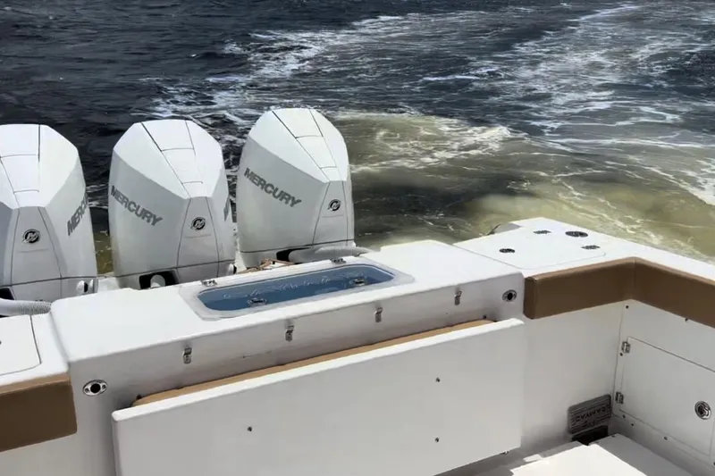 Slide: The Image of 2023 Caymas 341 CC boat with triple Mercury engines on water. - 36