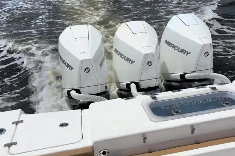 Slide: The Image of 2023 Caymas 341 CC boat with triple Mercury outboard engines on water. - 37