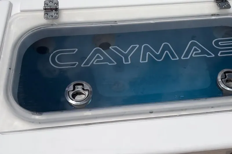 Slide: The Image of 2023 Caymas 341 CC boat livewell with logo and secure latches. - 38