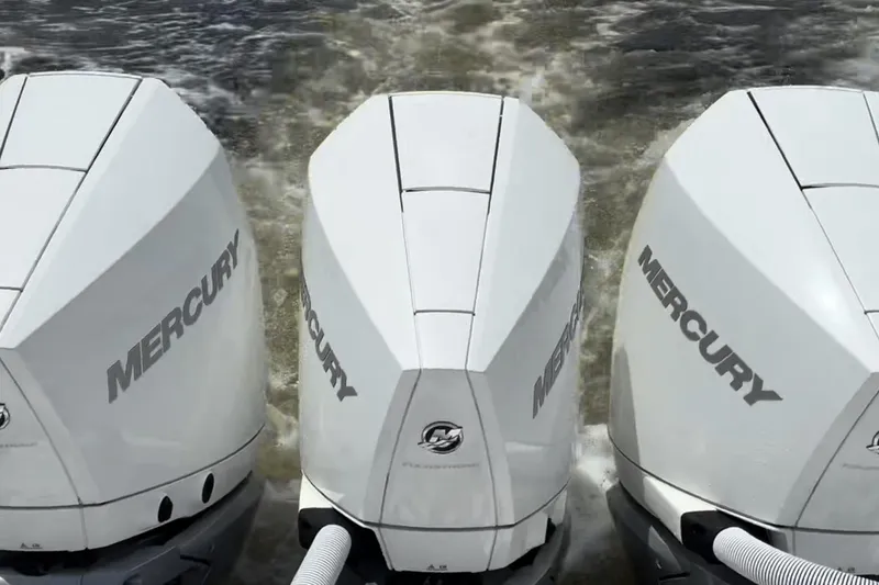 Slide: The Image of Triple Mercury outboard engines on 2023 Caymas 341 CC boat in action. - 40