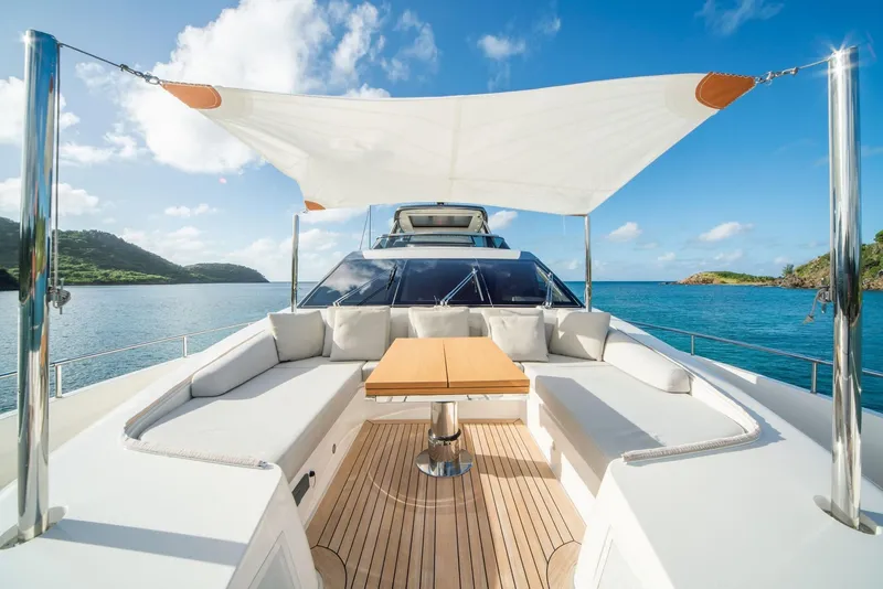 Slide: The Image of Sanlorenzo SL86 2018 yacht deck with seating, table, and sunshade, overlooking serene blue waters. - 12
