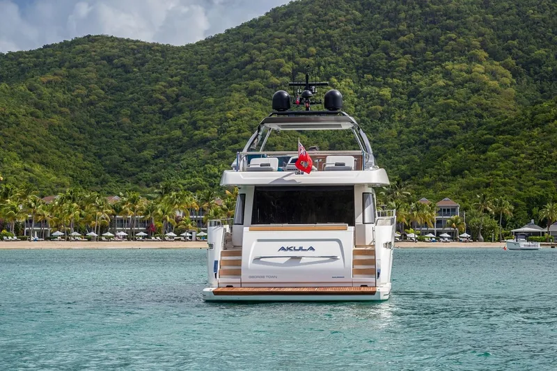 Slide: The Image of Sanlorenzo SL86 yacht, 2018 model, anchored in tropical waters with lush green hills. - 2
