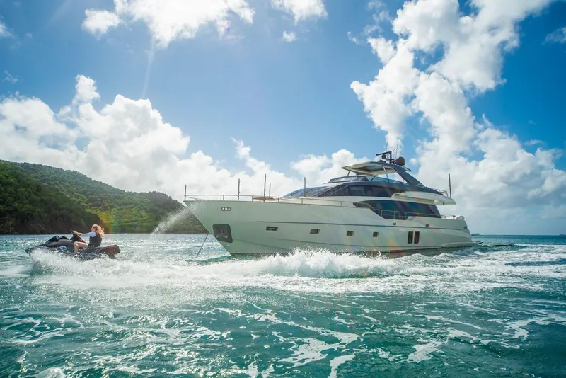 Slide: The Image of 2018 Sanlorenzo SL86 yacht cruising with jet ski nearby, under a bright blue sky. - 3