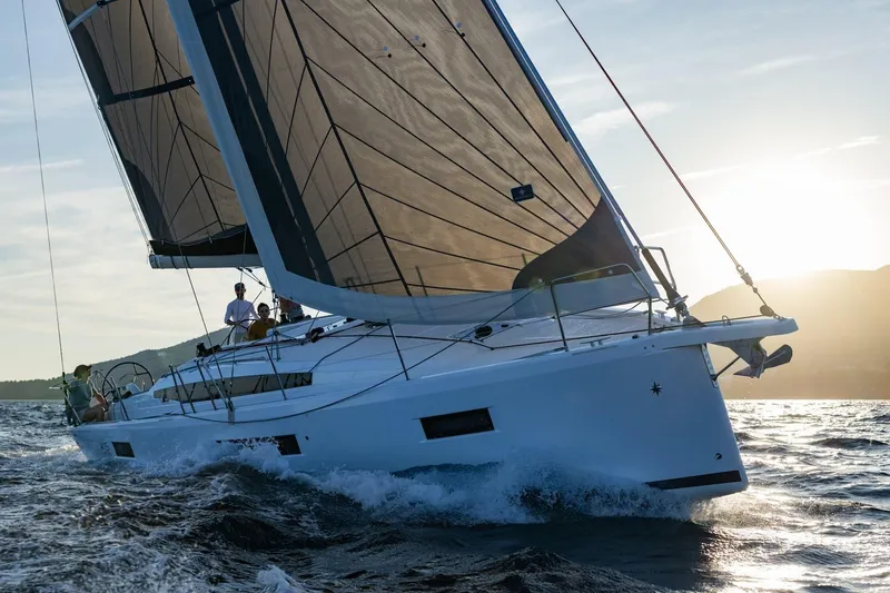 The Image of 2026 Jeanneau Sun Odyssey 415 sailing at sunset, cutting through waves. - 0