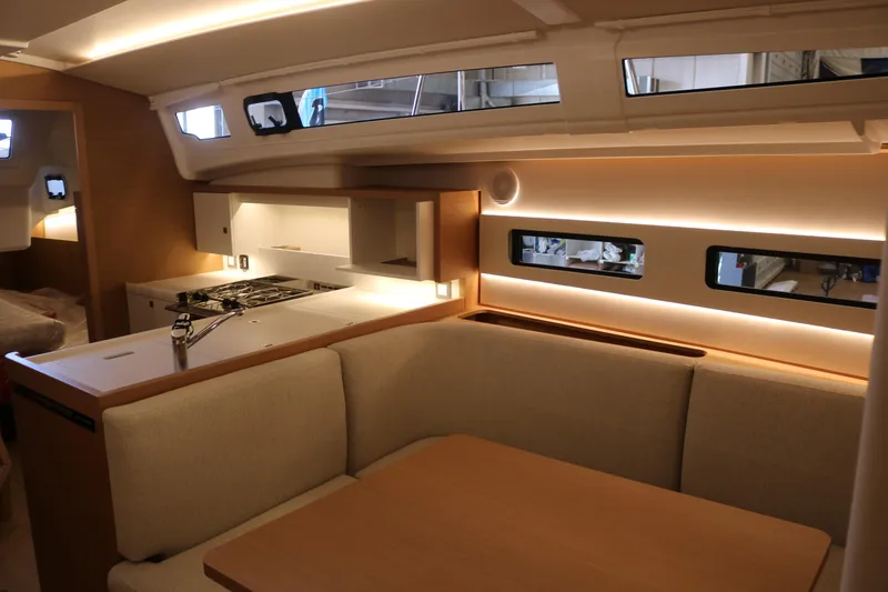 Slide: The Image of Interior of 2026 Jeanneau Sun Odyssey 415 yacht, featuring modern kitchen and cozy seating area. - 41