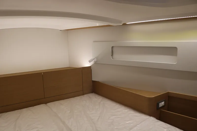 Slide: The Image of Interior cabin of 2026 Jeanneau Sun Odyssey 415 yacht, featuring modern wood finish. - 46