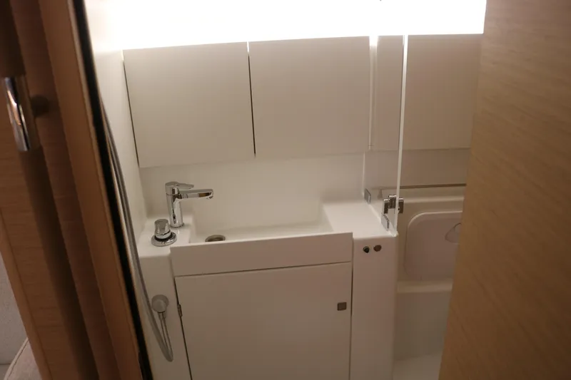 Slide: The Image of Modern bathroom interior of 2026 Jeanneau Sun Odyssey 415 yacht, featuring sleek white fixtures. - 35