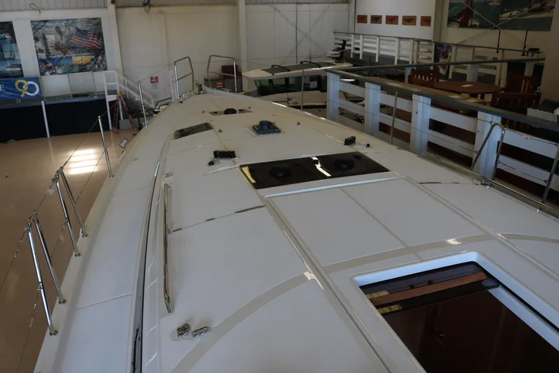 Slide: The Image of 2026 Jeanneau Sun Odyssey 415 yacht deck in a showroom setting. - 18