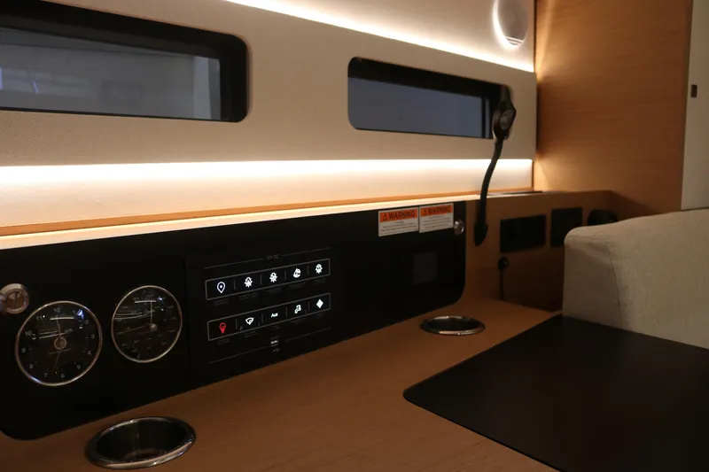 Slide: The Image of Interior of 2026 Jeanneau Sun Odyssey 415 yacht, featuring modern control panel and sleek design. - 42