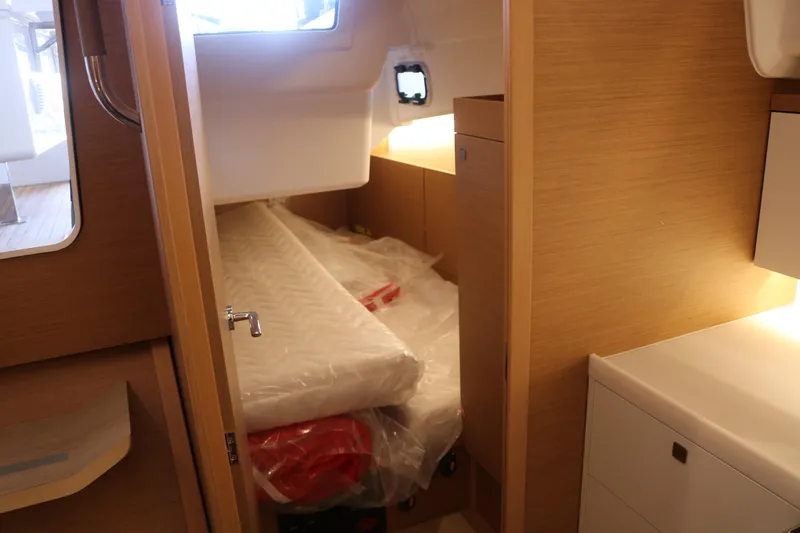 Slide: The Image of Interior cabin of 2026 Jeanneau Sun Odyssey 415 yacht, featuring a cozy bed and wooden finish. - 32