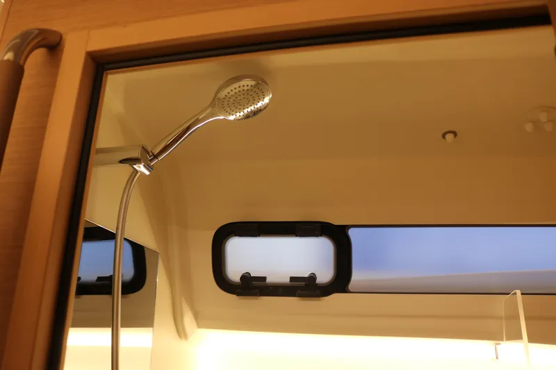 Slide: The Image of Shower area in 2026 Jeanneau Sun Odyssey 415 yacht, featuring modern fixtures and window. - 37