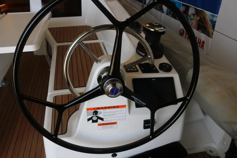 Slide: The Image of Steering wheel of 2026 Jeanneau Sun Odyssey 415 yacht, featuring modern navigation controls. - 14
