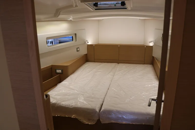 Slide: The Image of Interior cabin of 2026 Jeanneau Sun Odyssey 415 yacht, featuring twin beds and modern design. - 44