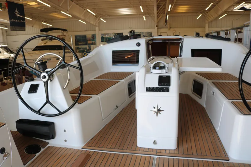 Slide: The Image of 2026 Jeanneau Sun Odyssey 415 yacht interior with dual steering wheels and teak decking. - 9