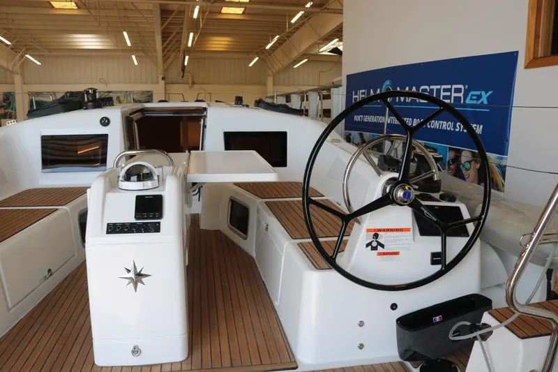 Slide: The Image of 2026 Jeanneau Sun Odyssey 415 yacht cockpit with modern steering and teak flooring. - 8