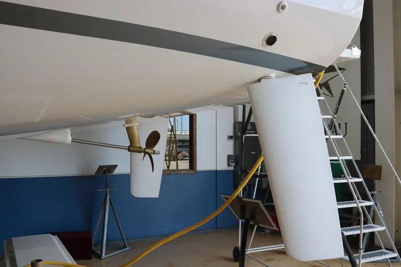 Slide: The Image of 2026 Jeanneau Sun Odyssey 415 sailboat under maintenance, showcasing propeller and rudder details. - 6