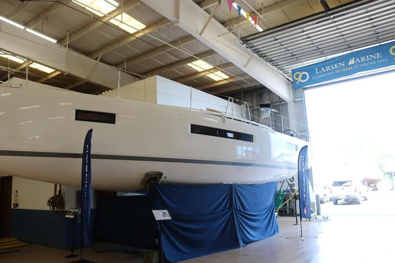 Slide: The Image of 2026 Jeanneau Sun Odyssey 415 yacht displayed indoors at Larsen Marine. - 7