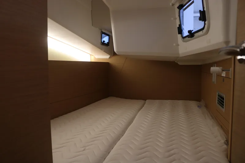 Slide: The Image of Interior cabin of 2026 Jeanneau Sun Odyssey 415 with twin beds and portholes. - 34