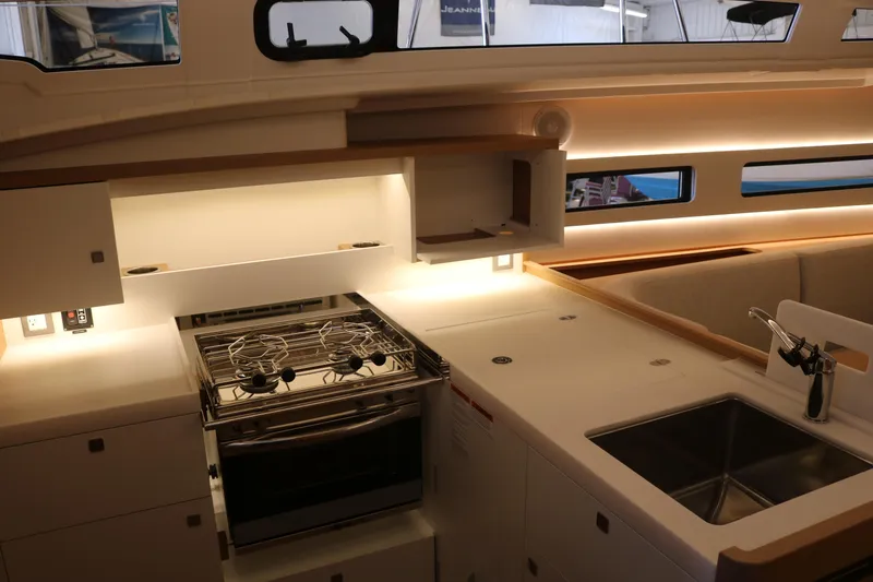 Slide: The Image of Modern kitchen interior of 2026 Jeanneau Sun Odyssey 415 yacht, featuring stove and sink. - 28