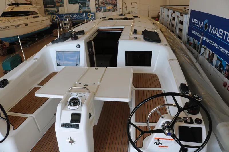 Slide: The Image of 2026 Jeanneau Sun Odyssey 415 sailboat interior with dual steering wheels and teak decking. - 20