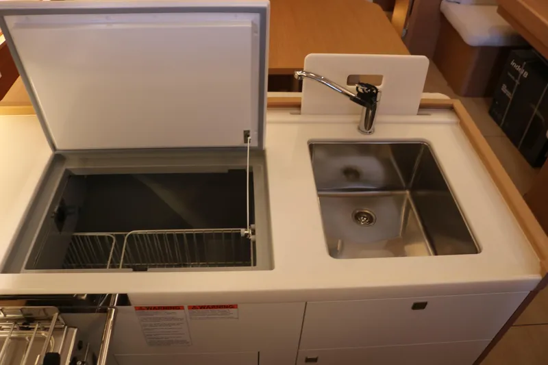 Slide: The Image of Modern kitchen area in 2026 Jeanneau Sun Odyssey 415 yacht, featuring sink and storage. - 30
