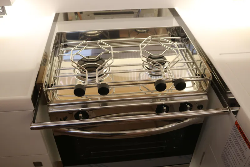 Slide: The Image of Modern stove in Jeanneau Sun Odyssey 415 yacht, 2026 model, featuring sleek stainless steel design. - 31