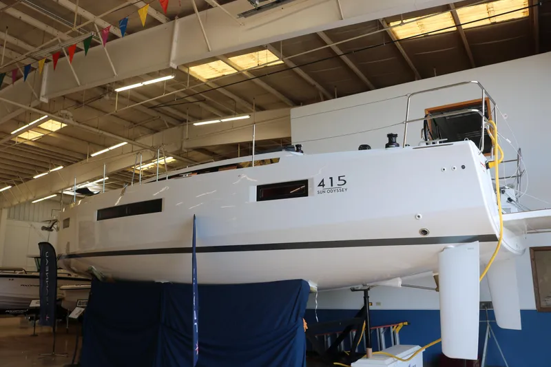 Slide: The Image of 2026 Jeanneau Sun Odyssey 415 sailboat displayed indoors, showcasing sleek design and modern features. - 4