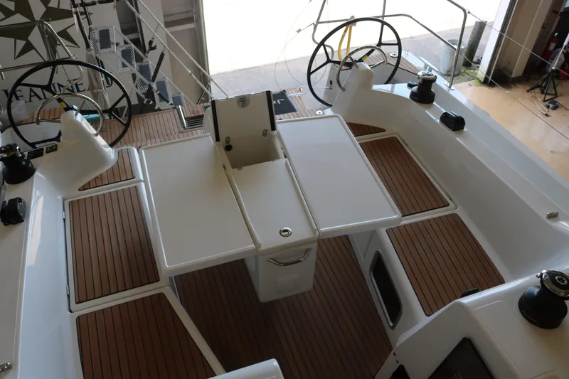 Slide: The Image of 2026 Jeanneau Sun Odyssey 415 cockpit with dual steering wheels and teak flooring. - 17