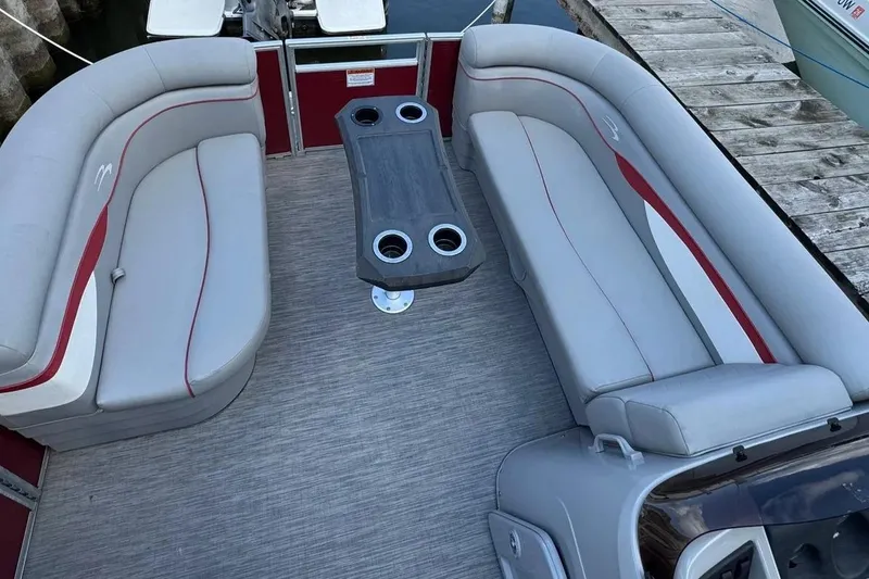 Slide: The Image of 2022 Bennington 198SL pontoon boat interior with gray seating and central table. - 17