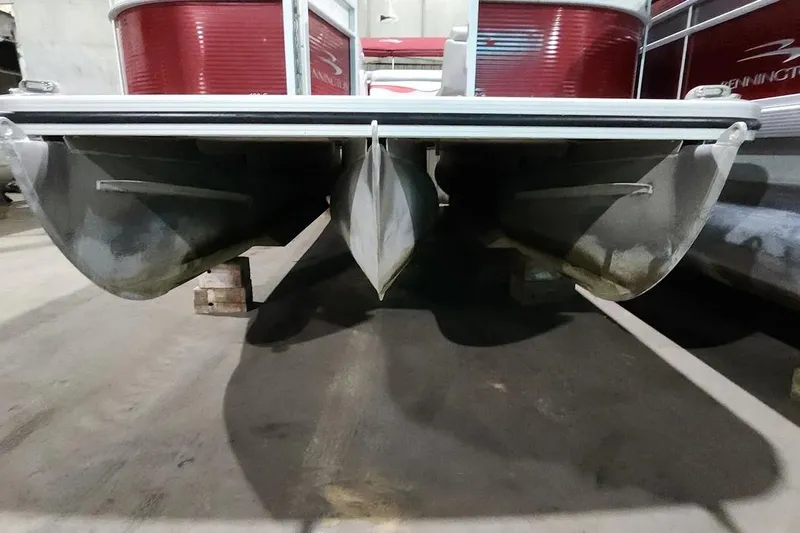 Slide: The Image of 2022 Bennington 198SL pontoon boat underside view in a storage area. - 19