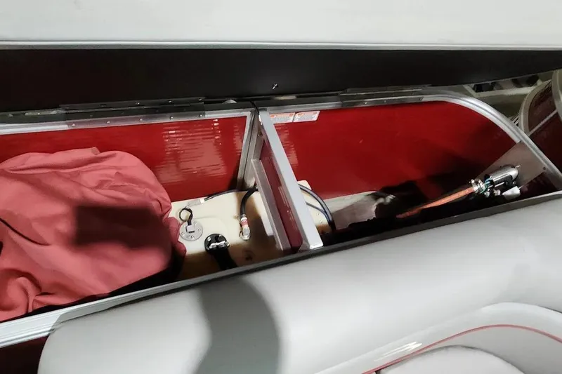 Slide: The Image of Storage compartment of 2022 Bennington 198SL boat with red interior and equipment. - 20