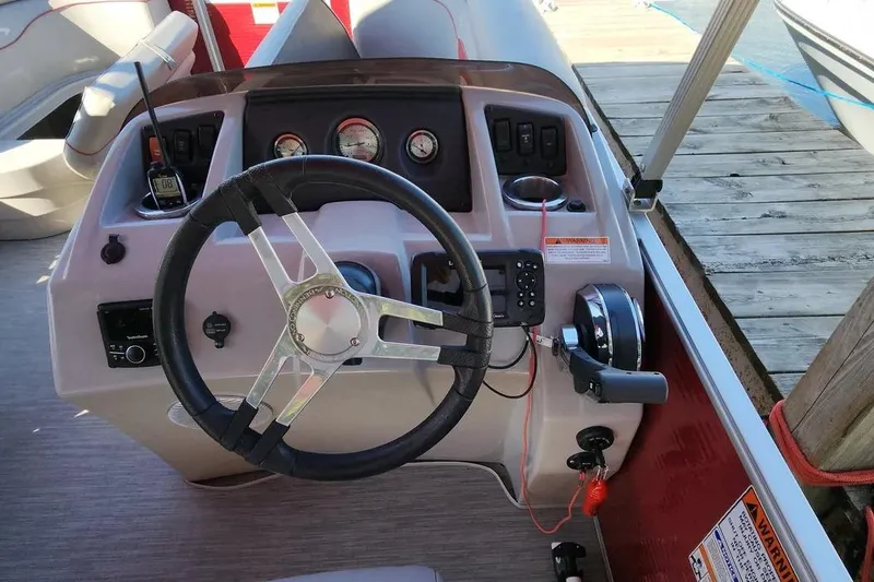 Slide: The Image of 2022 Bennington 198SL boat dashboard with steering wheel and controls. - 24