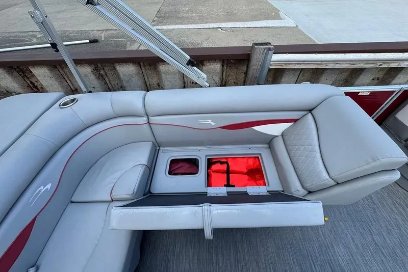 Slide: The Image of 2022 Bennington 198SL boat interior with gray seating and storage compartment. - 27