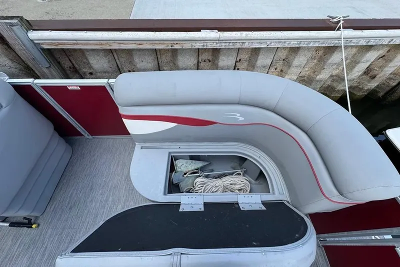 Slide: The Image of 2022 Bennington 198SL pontoon boat with open storage compartment and seating. - 28