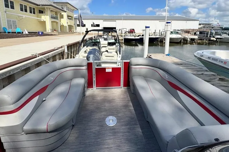 Slide: The Image of 2022 Bennington 198SL pontoon boat docked, featuring spacious seating and modern design. - 30