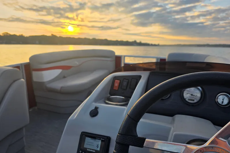Slide: The Image of 2022 Bennington 198SL boat interior with sunset view over the water. - 38