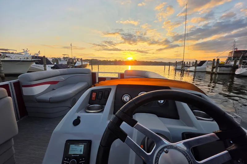 Slide: The Image of 2022 Bennington 198SL boat interior at sunset, docked with scenic water view. - 41