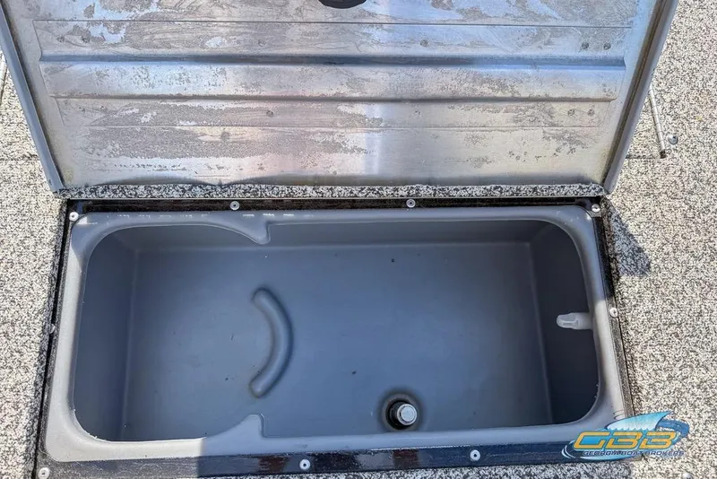 Slide: The Image of Open storage compartment in 2015 Tracker Super Guide V-16 SC boat. - 11