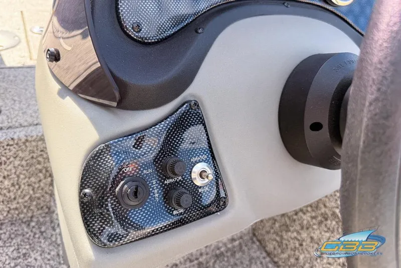 Slide: The Image of Control panel of 2015 Tracker Super Guide V-16 SC boat with switches and dials. - 13