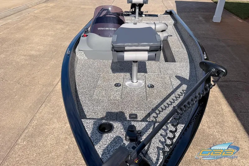 Slide: The Image of 2015 Tracker Super Guide V-16 SC fishing boat with gray interior and trolling motor. - 4