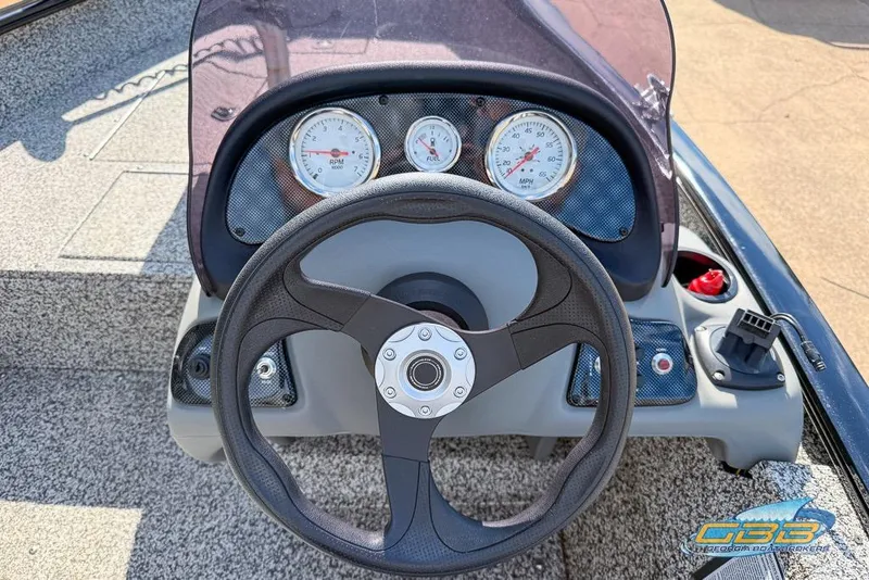 Slide: The Image of Steering console of 2015 Tracker Super Guide V-16 SC boat with gauges and controls. - 6