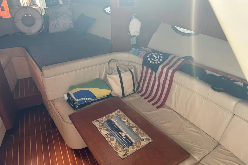 Slide: The Image of 1993 Tiara Yachts 3100 Open cabin interior with seating, table, and decor. - 12