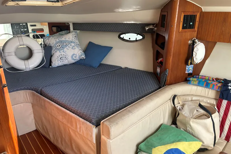 Slide: The Image of Cozy cabin interior of 1993 Tiara Yachts 3100 Open with cushions and nautical decor. - 15