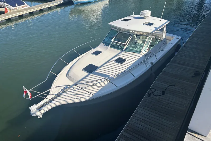Slide: The Image of 1993 Tiara Yachts 3100 Open docked at marina, viewed from above. - 21