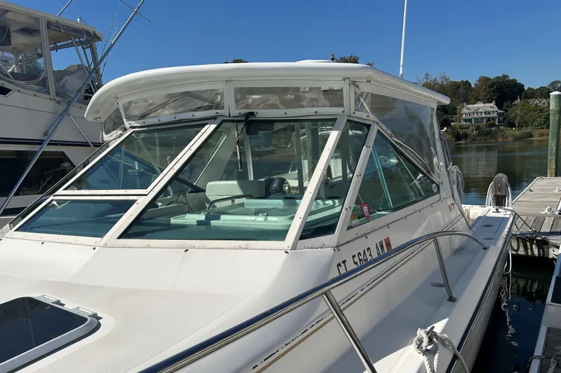 Slide: The Image of 1993 Tiara Yachts 3100 Open docked, showcasing sleek design and spacious cockpit. - 22