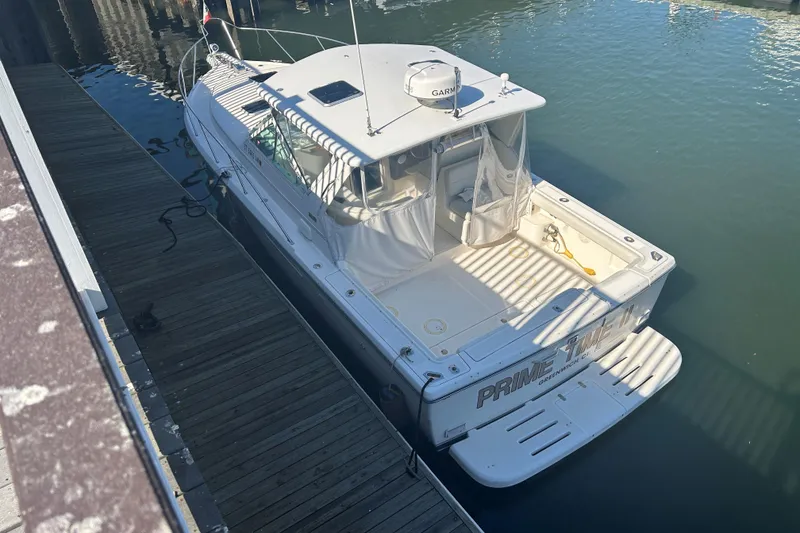 Slide: The Image of 1993 Tiara Yachts 3100 Open docked, rear view, sunny day. - 23