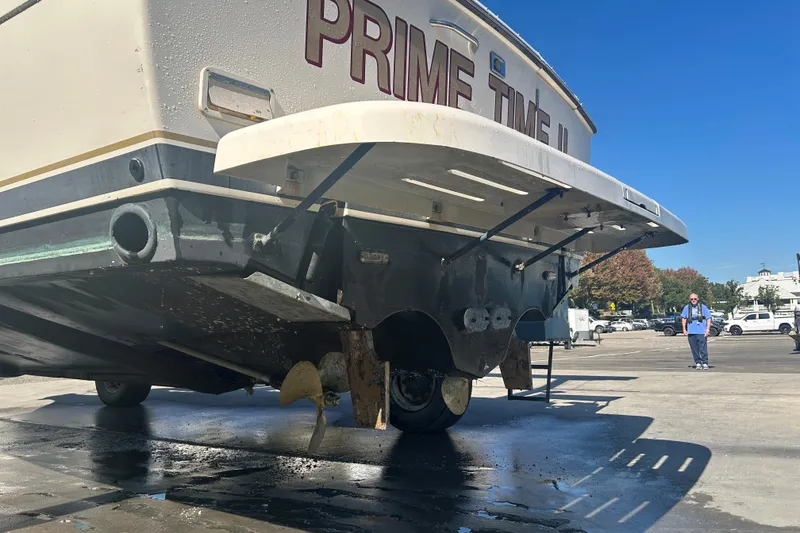 Slide: The Image of 1993 Tiara Yachts 3100 Open on dry dock, showcasing stern and propellers. - 33