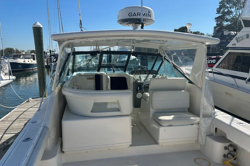 Slide: The Image of 1993 Tiara Yachts 3100 Open at dock, featuring spacious cockpit and Garmin equipment. - 4