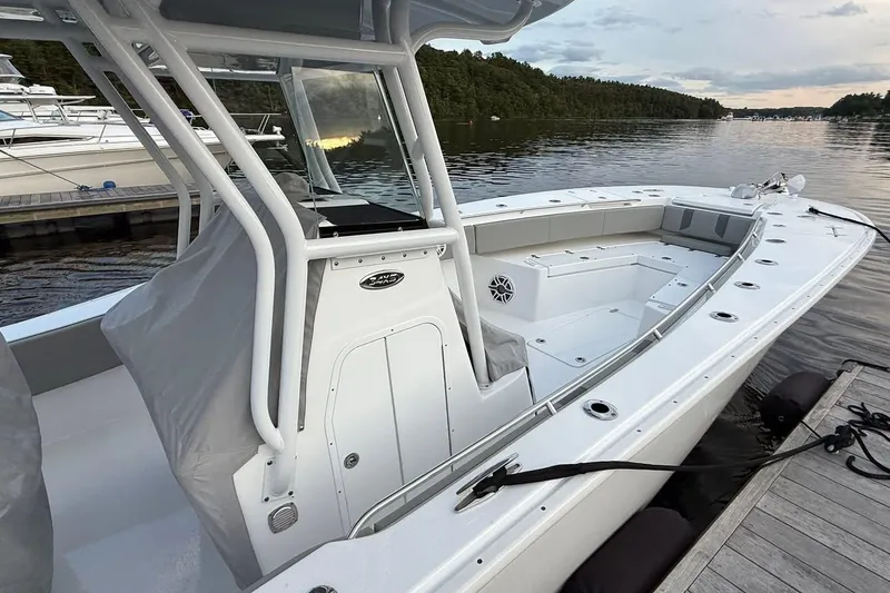 Slide: The Image of 2025 Cape Horn 34 XS boat docked on calm water, showcasing spacious deck and seating. - 10